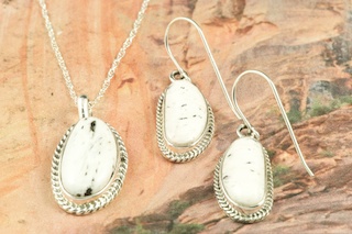 Genuine White Buffalo Turquoise set in Sterling Silver. Beautiful Pendant and Earring Set. 18" Sterling Silver Chain is included. This Beautiful Stone is formed from the minerals Calcite and Iron. It is mined near Tonopah Nevada. Created by Navajo Artist Tony Garcia. Signed by the artist.